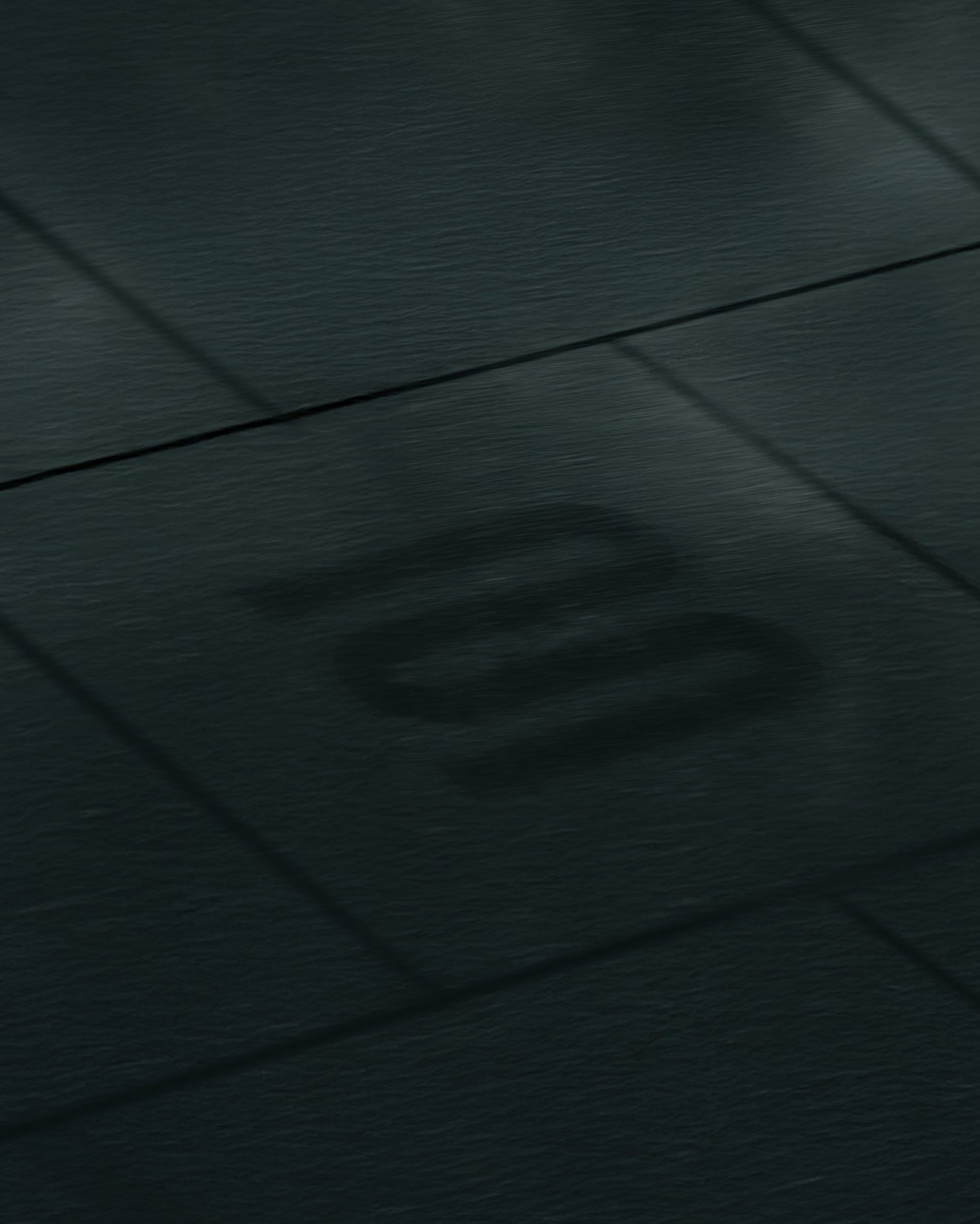 Close-up of a dark textured surface with a logo